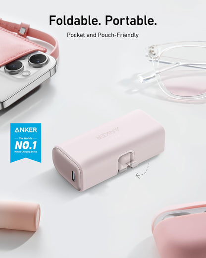 Anker power bank with built-in Lightning connector, 5000mAh capacity, compatible with iPhone 14/13/12 series, black color.