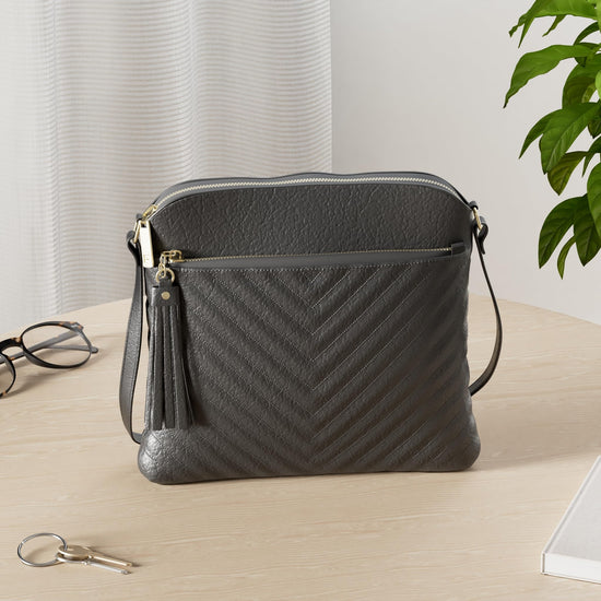 FashionPuzzle medium crossbody bag with tassel accent