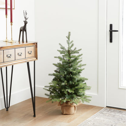 National Tree Company pre-lit artificial mini Christmas tree - 'Feel Real' design, 3 feet tall, burlap bag base and white lights.
